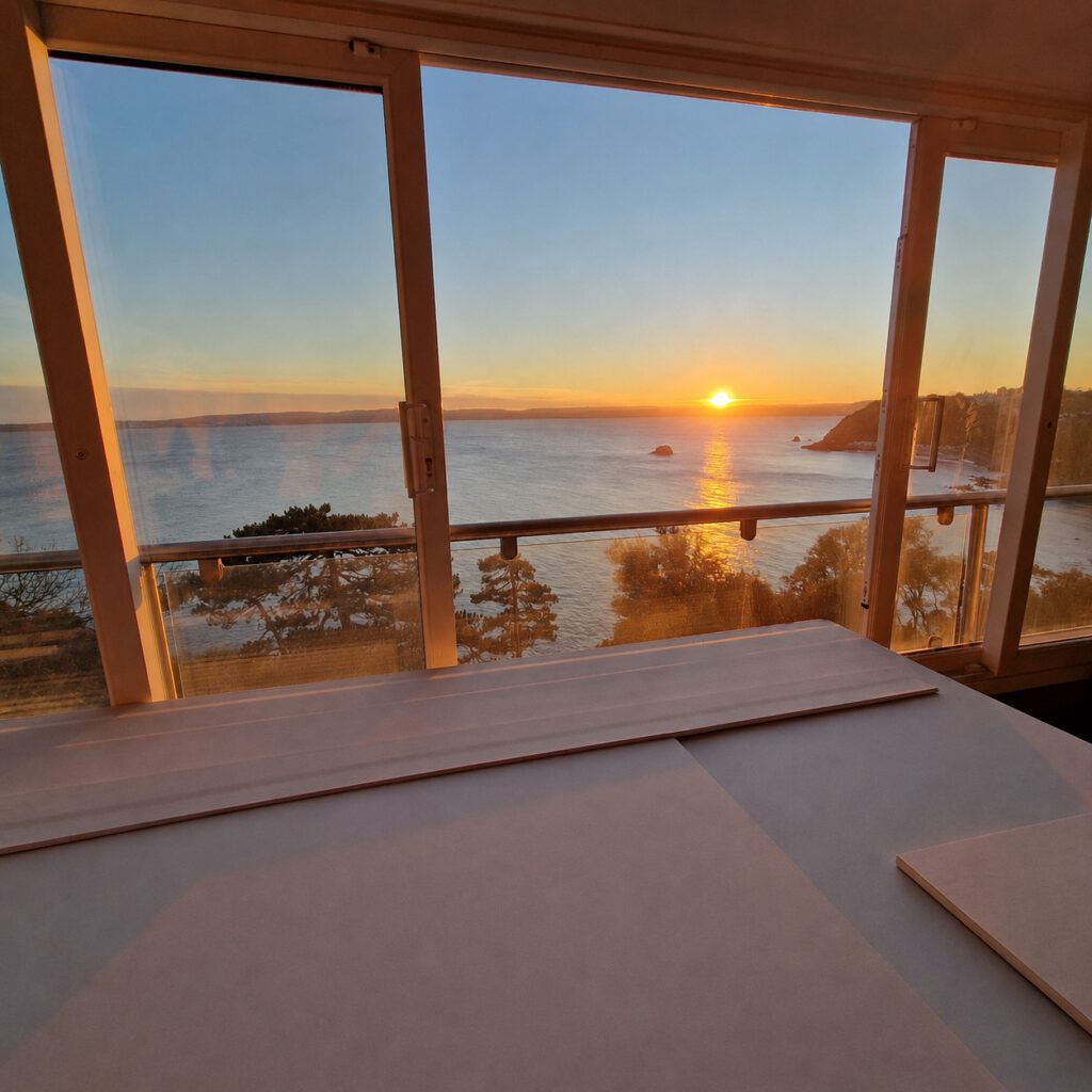 Sunset sea view from renovated coastal property with new sliding doors in South Devon