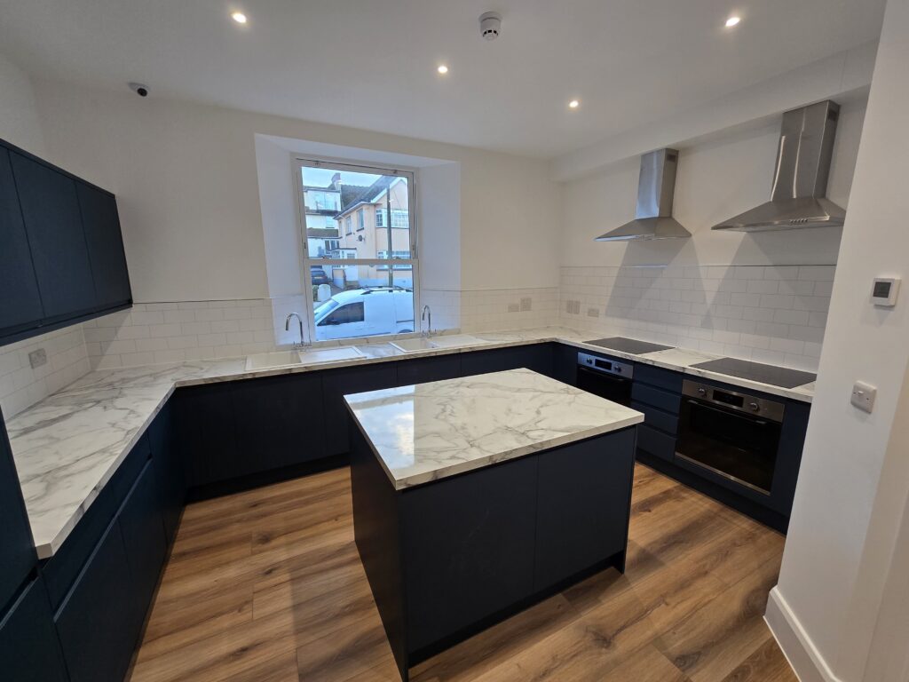 Fitted kitchen with island in YMCA assisted living flat